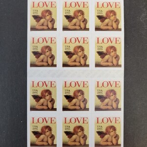 May include: Sheet of twelve "Love" postage stamps from 1995. Each stamp features a cherubic figure with red hair and feathered wings, resting their chin on their hand. The word "LOVE" is printed at the top, with "USA 1995" below.