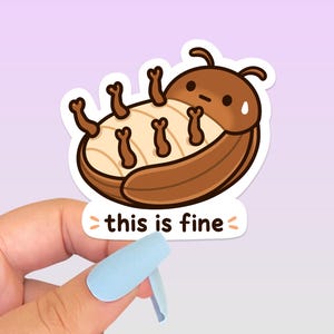 May include: A die-cut sticker featuring a cartoon brown beetle lying on its back with its legs in the air. The beetle has a cream-coloured underside and a worried expression with a sweat drop. Below the beetle, the text reads this is fine.