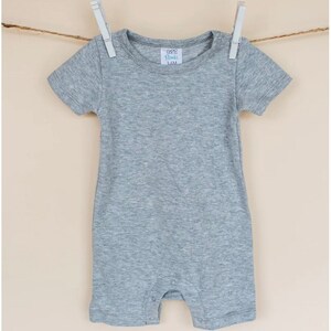 May include: A gray short-sleeved onesie with a white tag that says "GGG Basics 3-6M".