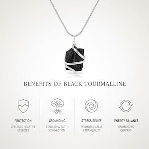 May include: A black tourmaline pendant necklace with a silver-colored wire wrap and chain. The image includes text describing the benefits of black tourmaline: protection, grounding, stress relief, and energy balance.
