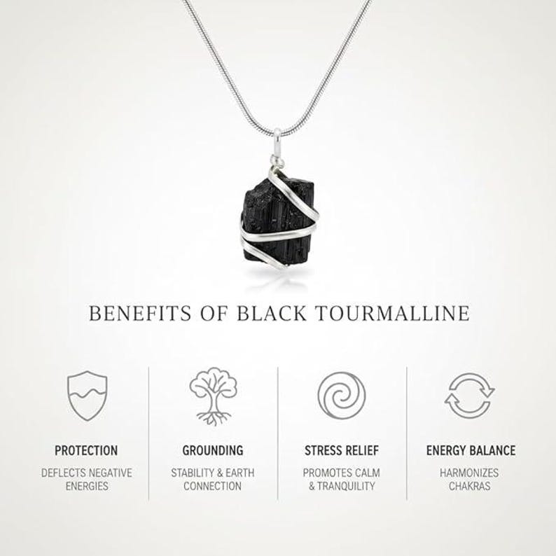 May include: A black tourmaline pendant necklace with a silver-colored wire wrap and chain. The image includes text describing the benefits of black tourmaline: protection, grounding, stress relief, and energy balance.