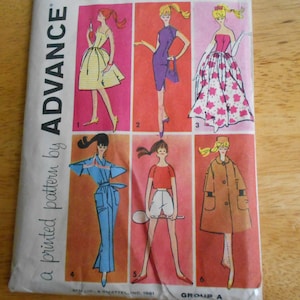 May include: An Advance sewing pattern envelope featuring six illustrations of outfits for a doll. The designs include a yellow dress, a purple sheath dress, a floral gown, a blue jumpsuit, a red top with white shorts, and a brown coat.