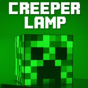 May include: A green pixelated Creeper Lamp, with the words "CREEPER LAMP" in white block letters above the lamp. The lamp is cube-shaped and features a Creeper face design.