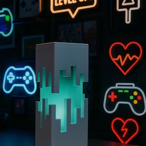 May include: A white, pixelated lamp with a teal glow, set against a dark background with neon gaming-themed signs. The signs include a controller, a heart, and the words "LEVEL UP!" in a speech bubble.