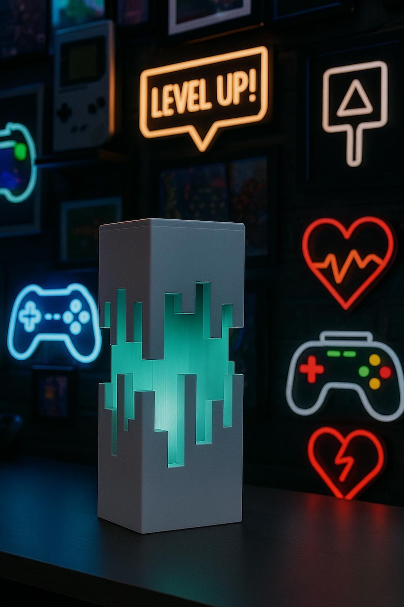 May include: A white, pixelated lamp with a teal glow, set against a dark background with neon gaming-themed signs. The signs include a controller, a heart, and the words "LEVEL UP!" in a speech bubble.