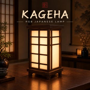 May include: A rectangular wooden lamp with a grid-patterned frame and translucent panels emitting a warm glow. The text KAGEHA RGB JAPANESE LAMP is displayed above the lamp, along with a red square icon containing a Japanese character.