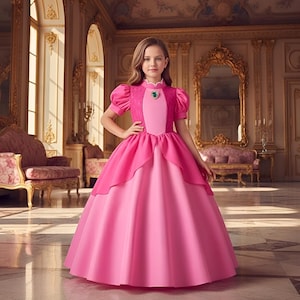May include: A young girl wearing a pink princess gown with a jewel-adorned neckline. The dress features a layered skirt and short, puffed sleeves. The background is a grand room with ornate gold accents and a large mirror.