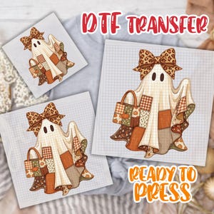 May include: A DTF transfer sheet featuring a ghost character wearing a large leopard print bow and carrying a patchwork tote bag. The ghost is draped in a cream-colored sheet with a grid pattern, accented by various brown, orange, and green patches.