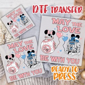 May include: DTF transfer sheets featuring Star Wars characters BB-8 and R2-D2 with Minnie Mouse ears, holding heart-shaped balloons. The text "MAY THE LOVE BE WITH YOU" is displayed in pink. The words "READY TO PRESS" are also visible.