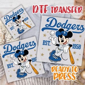 May include: A set of three ceramic mugs with a speckled, matte finish. The mugs are in shades of cream, light gray, and dark gray. Each mug has a simple, minimalist design and a rounded handle.