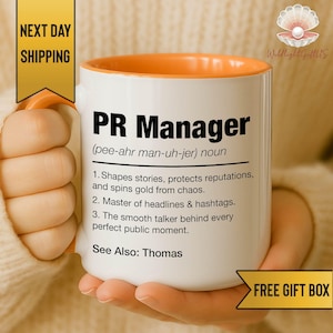 May include: White ceramic mug with an orange interior, printed with "PR Manager" in black. The mug includes a definition and three bullet points describing the role. The mug is held by a person.