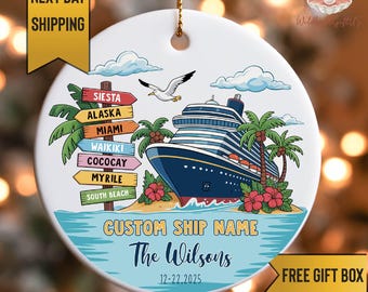 May include: A round ceramic ornament featuring a cruise ship illustration. The ship is blue with white accents, set against a tropical beach scene with palm trees and red flowers. Text includes "Custom Ship Name" and "The Wilsons".