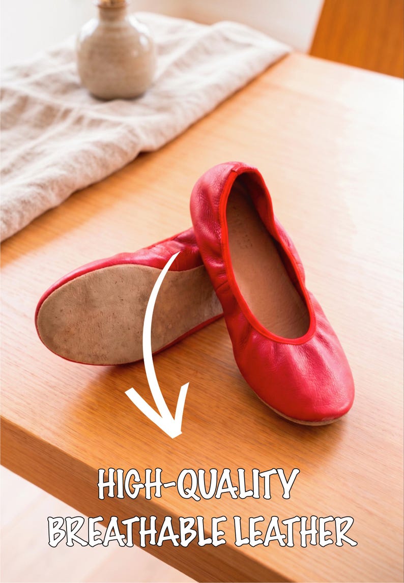 May include: A pair of red leather ballet flats. The shoes are displayed on a wooden surface, with the text "HIGH-QUALITY BREATHABLE LEATHER" below. A small vase and cloth are in the background.