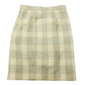 May include: A knee-length skirt with a plaid pattern in shades of cream and gray. The fabric appears to be a woven material, possibly wool or a wool blend. The skirt has a simple, classic design.