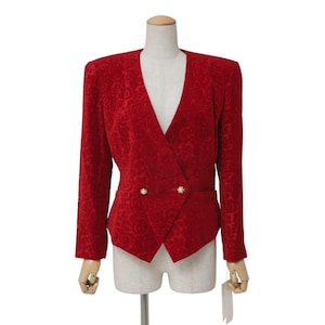 May include: A red blazer with a floral pattern, double-breasted with two gold-colored buttons. The jacket has a V-neck and long sleeves. The blazer is displayed on a mannequin.
