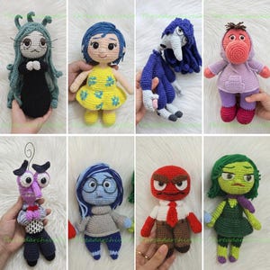 May include: A collection of eight handmade crochet dolls representing various characters. The dolls feature diverse colors, including green, yellow, blue, purple, red, and brown yarn, with detailed facial expressions, clothing, and hair textures.