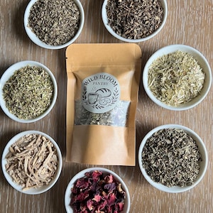 May include: A set of three ceramic mugs with a speckled, matte finish. The mugs are in shades of cream, light gray, and dark gray. Each mug has a simple, minimalist design and a rounded handle.