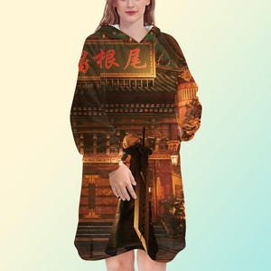 May include: A hooded sweatshirt featuring a detailed print of a traditional Asian building with red text. The design is printed on a white hooded sweatshirt.