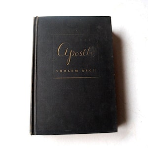 May include: A black hardcover book with the title "Apostle" in gold lettering on the front cover. The author's name, "Sholem Asch", is printed in smaller gold lettering below the title.