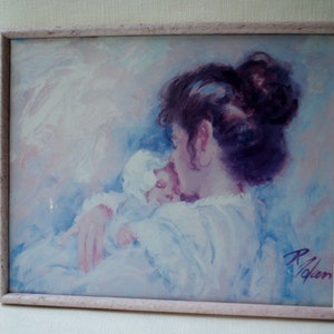 May include: A framed painting of a woman holding a baby. The woman has long dark hair and is wearing a white dress. The baby is wrapped in a white blanket. The painting is done in a soft, pastel style.