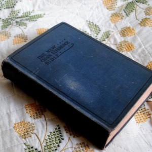 May include: A blue hardcover book with the title "The New Chain Reference Bible" on the cover.