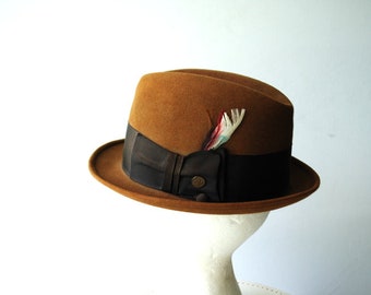 Classy vintage 50s, light brown felted , fedora , hight crown hat with a feather. Made by Champ.Size 6 7/8