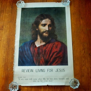 May include: A vintage religious poster featuring a painting of Jesus Christ with a red robe and blue cloak. The poster has the text "REVIEW: LIVING FOR JESUS" and a golden text quote: "If any man will come after Me, let him deny himself, and take up his cross daily."