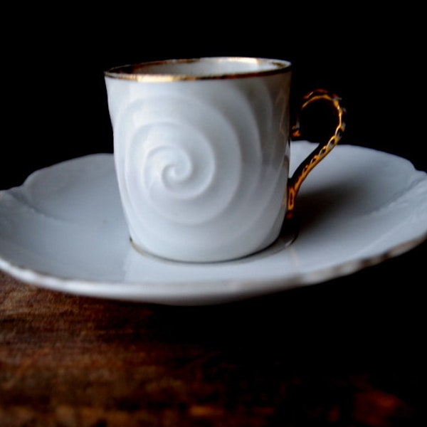 Antique style vintage 1990, white German porcelain demitasse set: cup and saucer with a swirl, scrolling design. By Leuchtens.