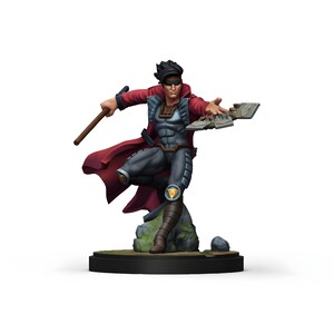 May include: A miniature figurine of a superhero in a dynamic pose. The figure wears a red cape, gray and blue armor, and brown boots. It is holding a wooden staff and a broken piece of stone. The figurine is mounted on a black circular base.