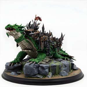 May include: A detailed fantasy figurine of a green dragon-like creature with a fortress on its back. The dragon has a detailed, textured skin, sharp claws, and an open mouth. The fortress is adorned with spikes, chains, and a small red flag.