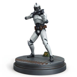 May include: A white and gray action figure of a soldier in a futuristic suit, holding a black rifle. The figure is posed on a gray platform with a circular base. The figure is approximately 8 inches tall.