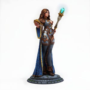 May include: A detailed figurine of a woman in fantasy attire, holding a glowing staff and a small orb. The figure wears a blue and gold gown, silver armor, and brown boots. The base is a stone platform.