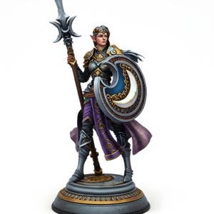 May include: A detailed figurine of a female warrior, holding a spear and shield. The warrior wears ornate armor with gold and blue accents, a purple skirt, and a silver circlet. The shield features a crescent moon design. The figurine stands on a decorative base.