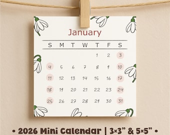May include: A small, square 2026 January calendar, held by a wooden clip. The calendar features a white background with floral accents and a monthly layout. The text "January" is in a burgundy color. The calendar is available in 3x3 and 5x5 inch sizes.