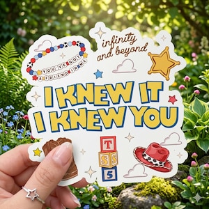 May include: A white die-cut sticker featuring the yellow text I KNEW IT I KNEW YOU. Graphics include a beaded bracelet with the text YOU'VE GOT A FRIEND IN ME, the text infinity and beyond, a gold sheriff star, a brown boot, a red hat, and blocks.