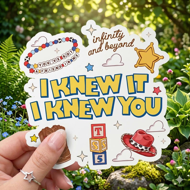 May include: A white die-cut sticker featuring the yellow text I KNEW IT I KNEW YOU. Graphics include a beaded bracelet with the text YOU'VE GOT A FRIEND IN ME, the text infinity and beyond, a gold sheriff star, a brown boot, a red hat, and blocks.
