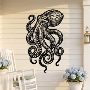 May include: A large, black metal octopus wall art piece. The octopus is intricately designed with detailed patterns on its head and tentacles. It is mounted on a white wall, creating a striking contrast. The art adds a nautical theme to the outdoor space.