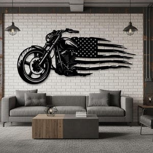 May include: Black metal wall art depicting a motorcycle with an American flag design. The motorcycle is detailed with a large front wheel and engine. The flag design is stylized with flowing stripes. The art is mounted on a white brick wall.