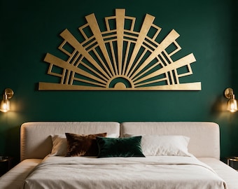 May include: A large, semi-circular gold wall art piece featuring a geometric sunburst pattern with radiating lines and rectangular accents. The structure is mounted horizontally on a dark green wall above a beige upholstered bed frame.
