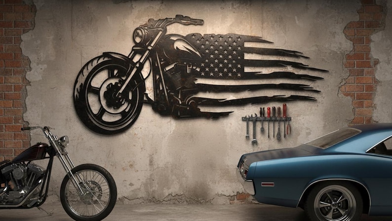 May include: Black metal motorcycle wall art with an American flag design. The motorcycle is depicted in profile, with the flag incorporated into the design. A classic blue car and a motorcycle are in the foreground.