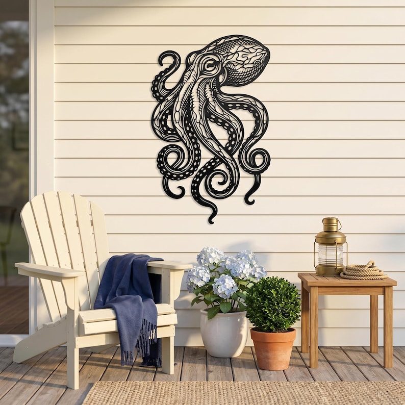 May include: Black metal octopus wall art. The octopus has detailed tentacles and a textured head. The artwork is mounted on a white wall, suggesting outdoor or nautical decor. The octopus is a decorative element.
