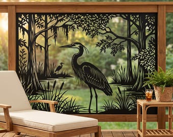 May include: A black metal decorative privacy screen featuring a detailed laser-cut silhouette of a large heron standing in a swampy landscape with trees, hanging moss, and cattails. The design depicts a natural wetland scene with a smaller bird.