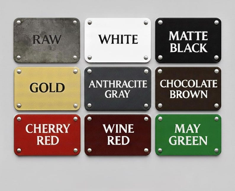 May include: Nine rectangular metal signs with different color finishes and text. The signs include colors like raw, white, matte black, gold, anthracite gray, chocolate brown, cherry red, wine red, and may green. Each sign is secured with four silver rivets.