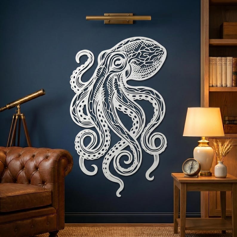 May include: A large, white, laser-cut octopus wall art piece. The intricate design features detailed tentacles and a textured head, mounted on a dark blue wall. The artwork adds a nautical theme to the room's decor.