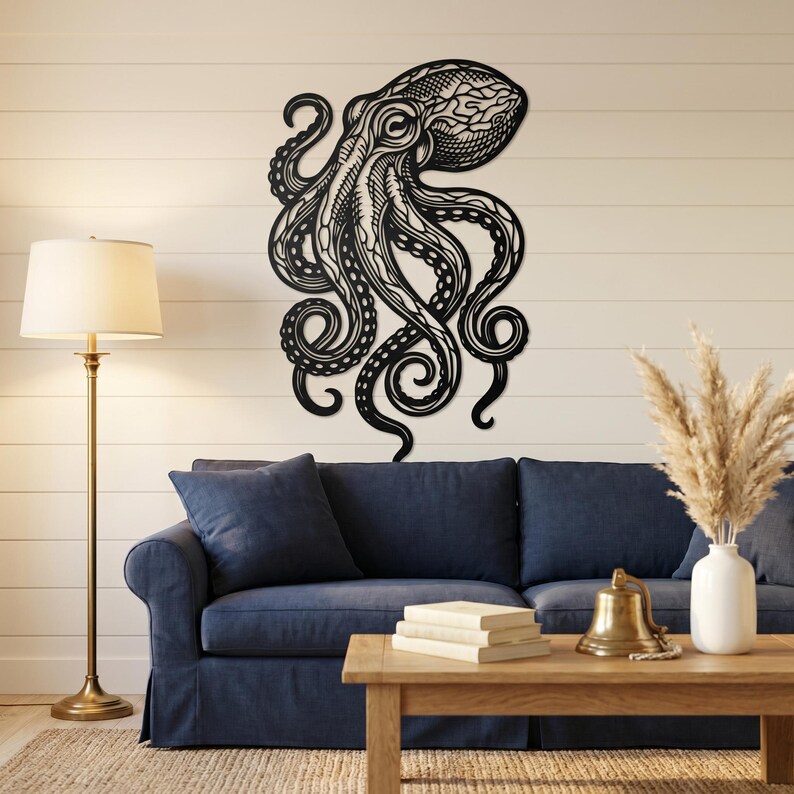 May include: A large, black metal octopus wall art piece. The octopus is intricately detailed with swirling tentacles and a textured head. It is mounted on a white wall above a blue sofa, creating a striking contrast. The artwork adds a nautical theme to the room.