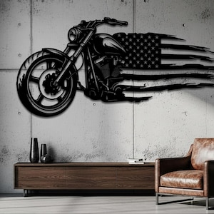 May include: Black metal motorcycle wall art with an American flag design. The motorcycle is depicted in profile, with the flag appearing to be blowing in the wind. The artwork is mounted on a concrete wall.