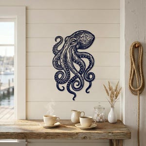 May include: A navy blue metal octopus wall art piece. The octopus is intricately designed with detailed lines and patterns. It is mounted on a white wall, creating a striking contrast. The artwork adds a nautical theme to the space.