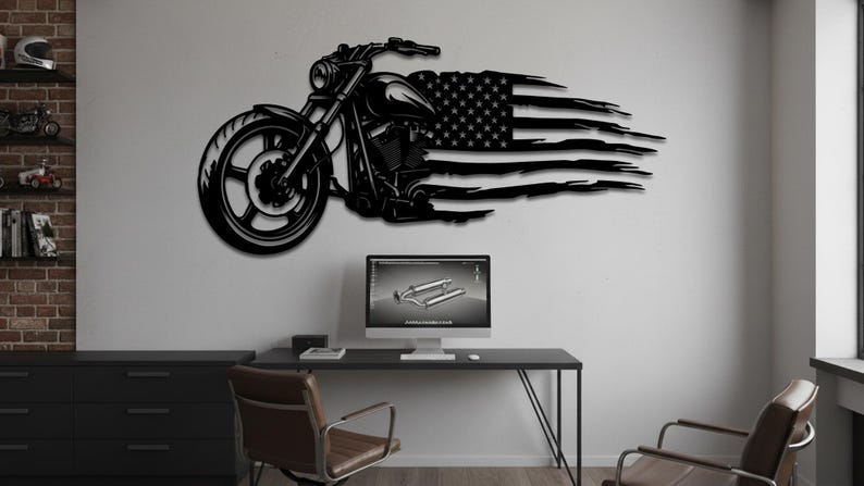 May include: Black metal motorcycle wall art with an American flag design. The motorcycle is depicted in profile, with the flag appearing to stream behind it. The artwork is mounted on a white wall, above a black desk and chair.