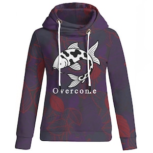 May include: A purple hoodie featuring a koi carp design in black and white. The hoodie has a cowl neck with white drawstrings and the word "Overcome" printed in white. The background has a pattern of red leaves.
