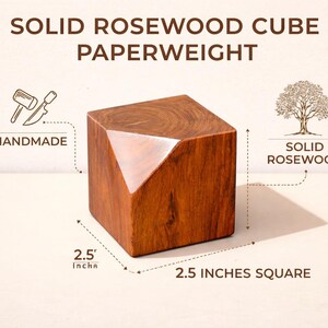 May include: Solid rosewood cube paperweight, handmade from solid rosewood. The cube is 2.5 inches square with a faceted design on one corner. The wood has a rich, warm brown color.